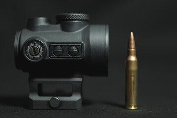 Red dot sight for firearms, close-up photo.