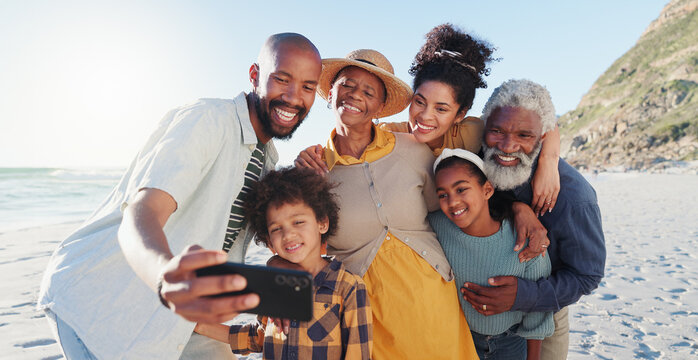 Love, selfie and happy family at a beach for travel, fun or adventure in nature together. Ocean, profile picture and African kids with parents and grandparents at the sea for summer, vacation or trip