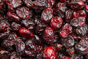 Dried cranberries texture food background. Heap of red autumn berries closeup