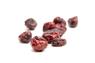Dried and sweetened cranberries isolated on white background, top view. Heap of scattered cranberries closeup