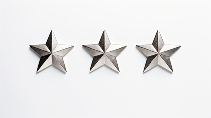 Obraz premium three metal stars are on a white surface