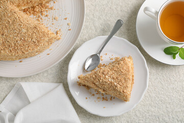 Delicious Napoleon cake served on beige table, flat lay
