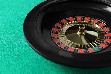 Roulette wheel with ball on green table, closeup. Casino game