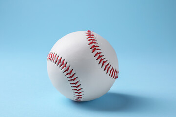 One baseball ball on light blue background