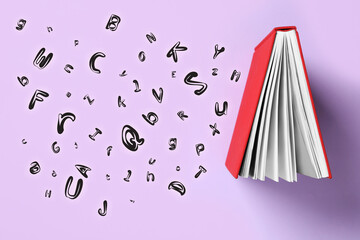 Book and flying letters on lilac background, top view