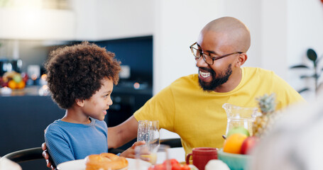 Black family, food and father with child for breakfast, lunch and eating together in home. Happy, talking and dad and boy at table for bonding with meal for health, nutrition and hunger in house