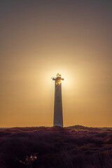 View on the lighthouse at sunset with sun behind it in Morro Jable, Jandia on the Canary Island...