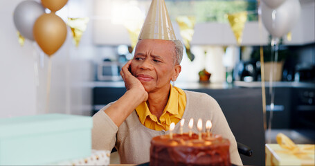 Sad, birthday and senior woman thinking with depression, grief and lonely in her home. Cake, face...