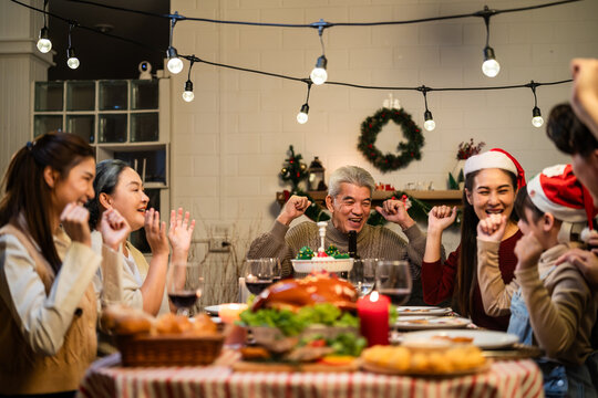 Asian lovely family celebrating Christmas party together in house. 