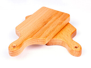 Two wooden cutting boards on a white table - 695662150