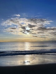 美しい海岸の夕焼け、光る海と沈む太陽、光る海と青い空の太陽、銀色の海と青い空、夕暮れ時の海の風景