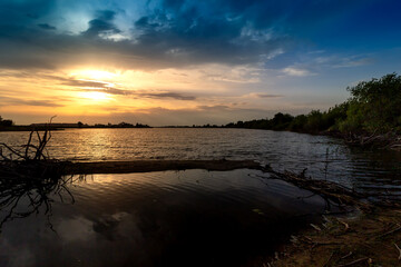 Magic sunset over lake. Early evening, rural landscape, wilderness, mystical feeling.