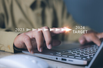 Businessman pointing target in 2024. Progress business growing potential success