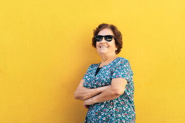 Stylish old woman in sunglasses and colorful clothes