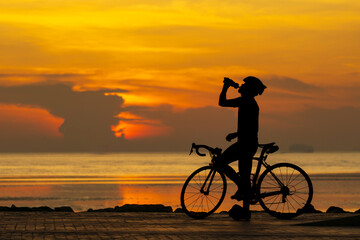 Obraz premium silhouette of a person riding a bike on sunset