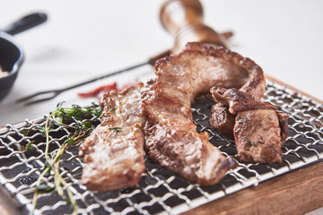 Oily and delicious pork barbecue on a small grill