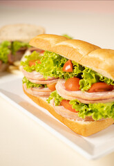 Sandwich Ham with salad tomato on white plate