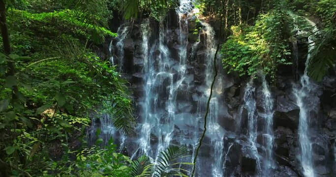 Kanto Lampo waterfall in lush tropical forest, Bali, Indonesia