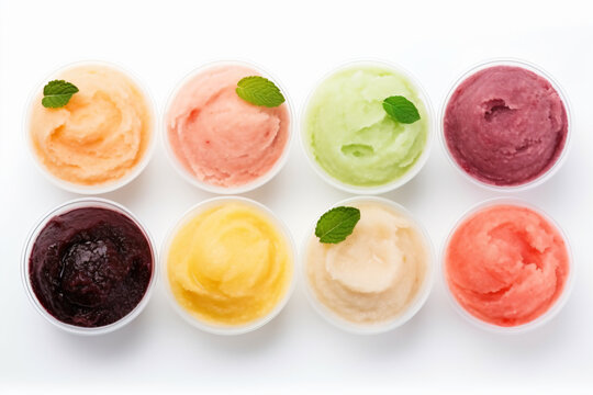 a group of different colored ice creams in small bowls