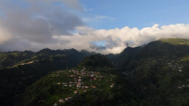 Drone footage of incredible mountains and landscapes in Madeira Portugal filmed at sunrise. Hills covered in greenery.
