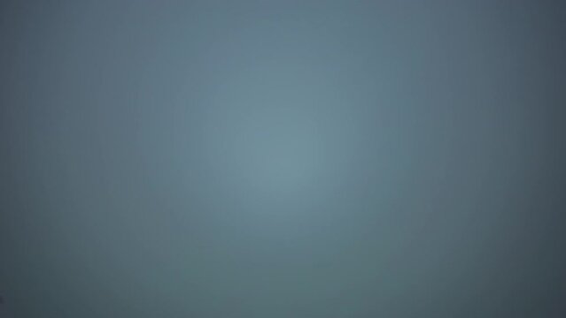 A wooded mountain area is completely made invisible by the rising fog.