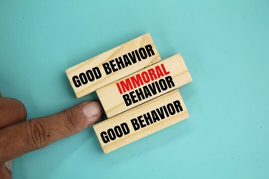 wood with the words good behavior and immoral behavior. the concept of behavior or ethics. the word immoral behavior is rejected