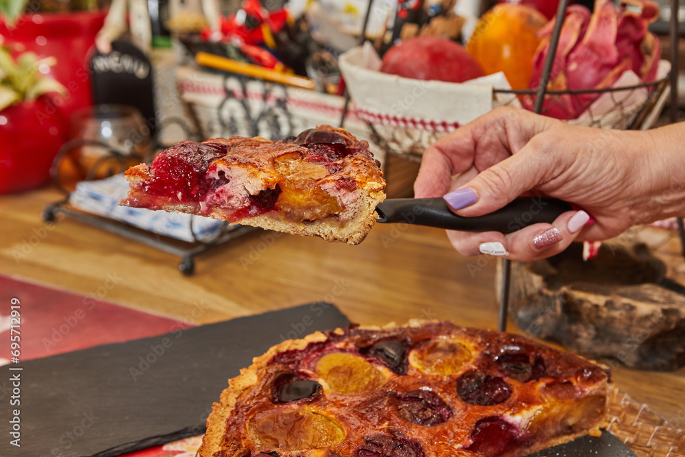 Wall mural Slicing of Delicious Homemade Plum Pie Baked in Electric Oven