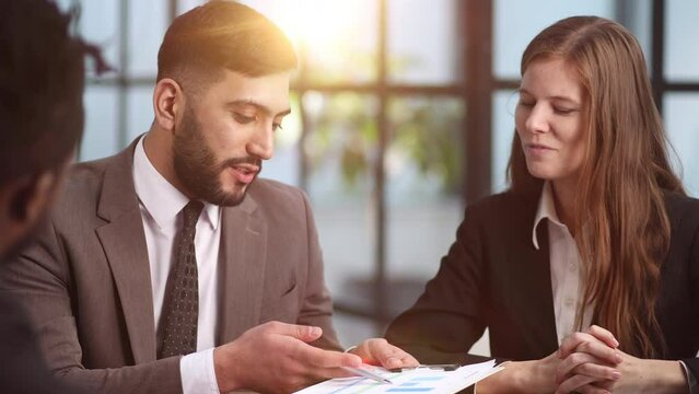 sitting at the table. Young business people working in the office