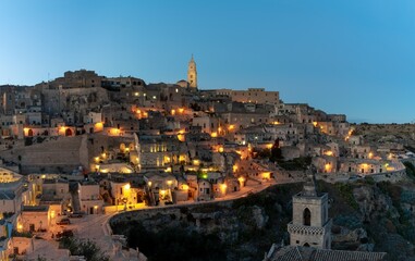 Fototapeta premium view of the old town of Matera after sunset with the lights coming on
