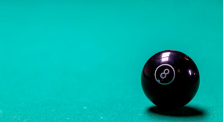 Classic billiard ball with number 8 on green table