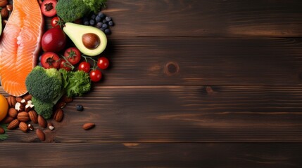 nutrient-rich delight: fresh salmon, avocado, broccoli, vibrant vegetables, nuts, and fruits on wooden background. top view with copy space