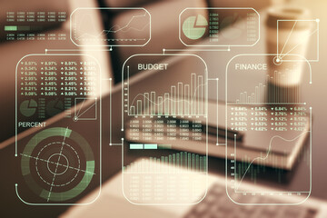 Multi exposure of creative statistics data hologram on laptop background, stats and analytics concept