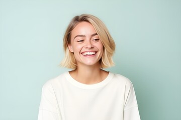 Joyful Young Woman with a Beaming Smile on Soft Aqua Background. Generative AI.