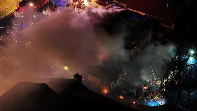 Aerial View of a House Fire With Flames and Smoke Through the Roof
