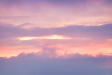 A beautiful sky tinted by the sun leaving vibrant shades of gold, pink, blue and multicolored. Clouds in the twilight evening and morning sky. Image of a cloudy sky in the evening and during the day