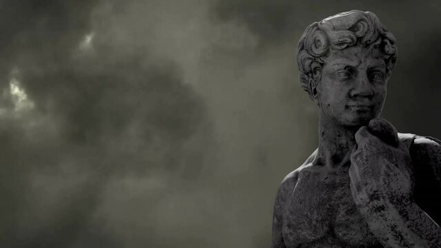 Animation of gray sculpture of man over dark sky and storm clouds, copy space