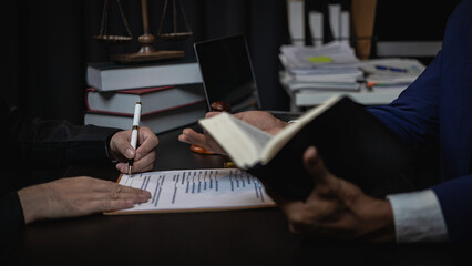 Lawyer holds a pen and provides consulting services in business disputes with a scale and hammer. In the event that the customer is defrauded Close-up pictures - obrazy, fototapety, plakaty