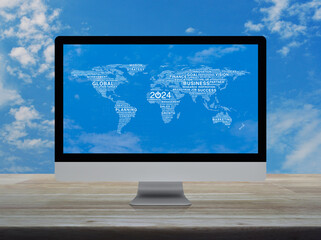 Start up business icon with global words world map on computer monitor screen on table over sky,...