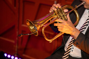 man Playing trumpet in suit during event