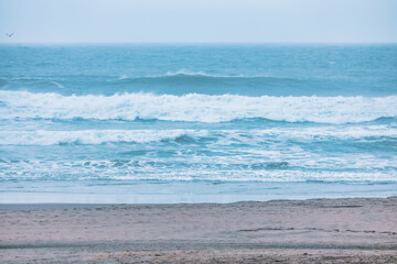 Wave splashing close-up. Crystal clear sea water, in the ocean in San Francisco Bay, blue water, pastel colors.