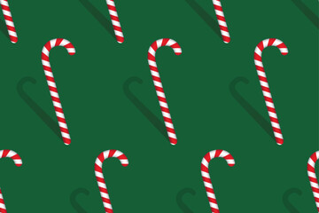 Christmas red and white candy cane with shadow on green background. Seamless pattern. Vector illustration.