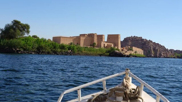 Aswan, Egypt: Boat sailing toward the ancient Philae temple in Aswan in lake Nasser from by the Nile river in Egypt. 
