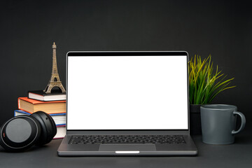 Fototapeta premium Laptop with blank screen on table against black background