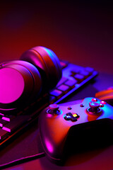 Headphones, joystick and computer keyboard on black table © fotofabrika