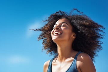 Stock photography of a black African American woman. Mind. Launching, blue sky background