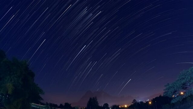 Startrails in winter starry night sky  Time lapse Comet Effect, Star trails in dark space background landscape in the nature