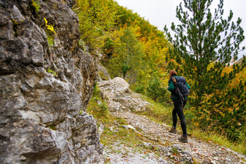 Naklejka na ściany i meble Woman on a Hiking Trail Exploring the Albanian Alps