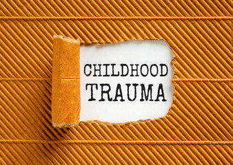 Childhood trauma symbol. Concept words Childhood trauma on beautiful white paper. Beautiful brown...