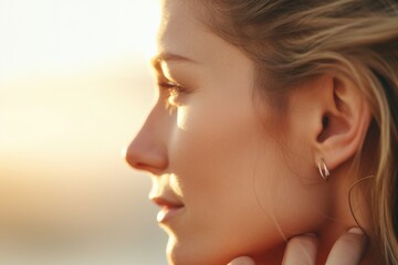 Obraz premium A detailed close-up of a person showcasing their ear piercings. This image can be used to illustrate body modifications or to showcase different earring styles