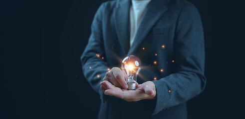 Successful Innovation through ideas and inspiration ideas. Human hand holding light bulb to...
